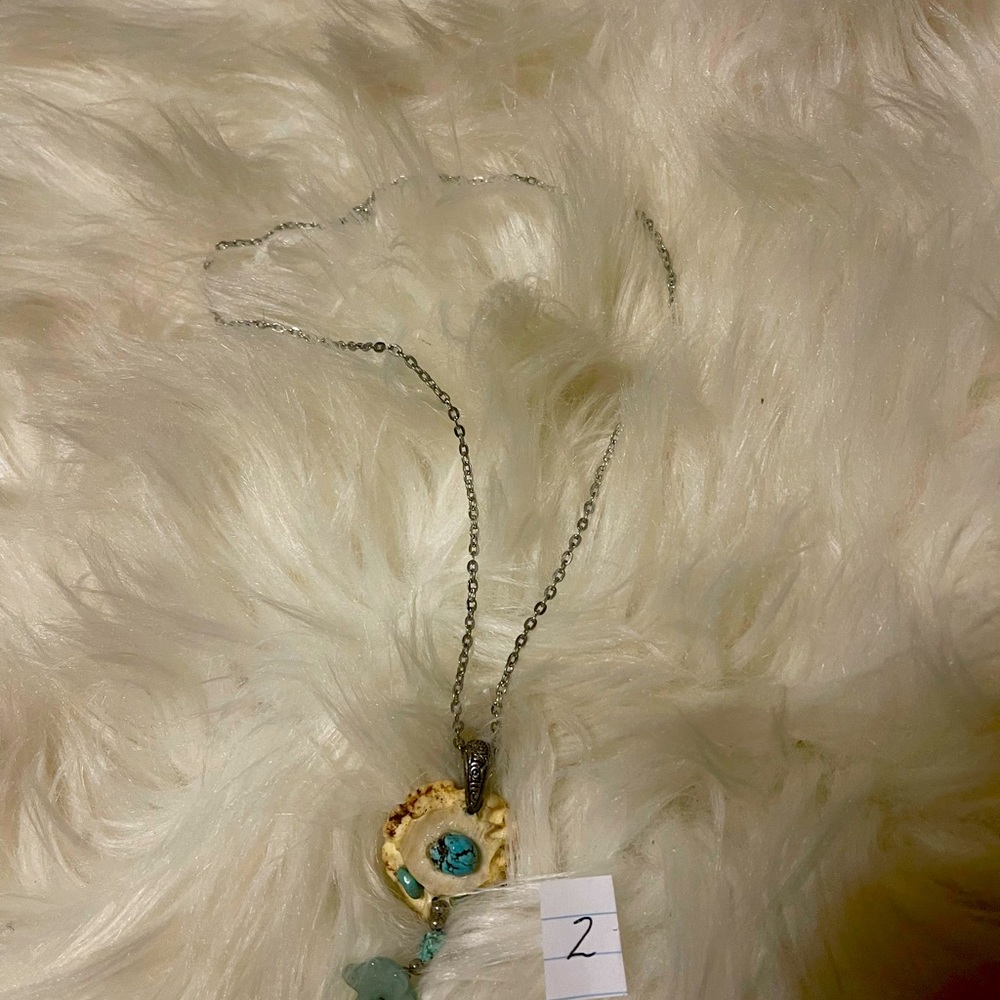 Abstract pendant with turquoise and silver chain.